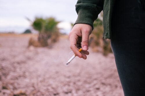 Man Holding A Cigarette Wanting to Quit Smoking